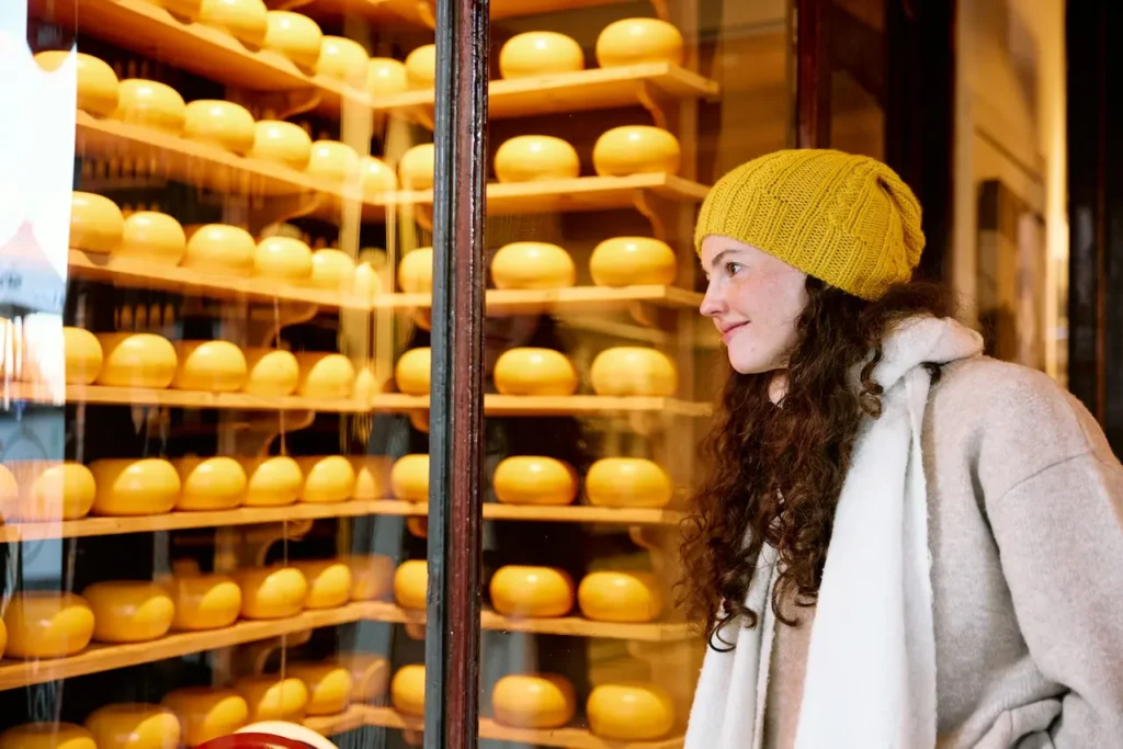 Lady Looking At Cheese In A Window